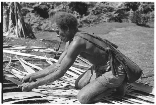 Splitting of bark to make the container to carry the finished taro and coconut pudding for presentation, and the making of the container