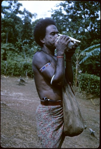 Man blowing conch