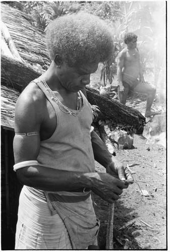 Portrait of man in t-shirt working with kofu shell money