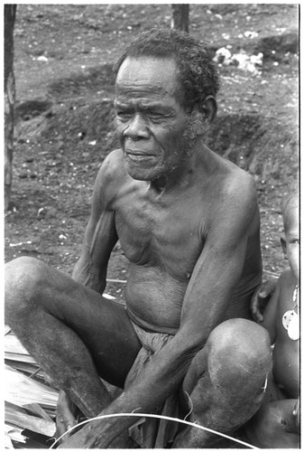 Man tying palm thatch panels