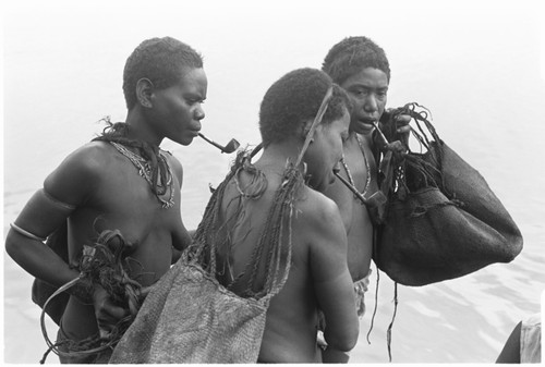 Trading with saltwater (coastal) women in the canoes. Bush women