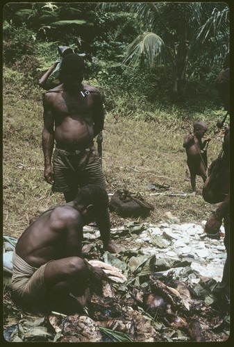 Men preparing pork