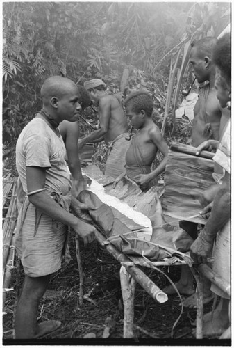 Making the taro and coconut puddings on platform near the sango dance ground