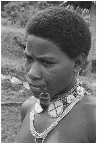 Portrait of woman wearing customary finery, girimalaile pendants string