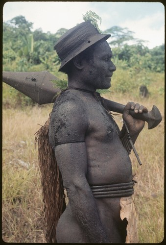 Basiitau painted black, wearing his very old cane hat