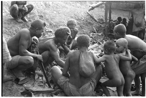 Men eating gwasu taro and coconut pudding