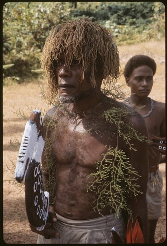 Ma'aanamae with wig and taba dance stick