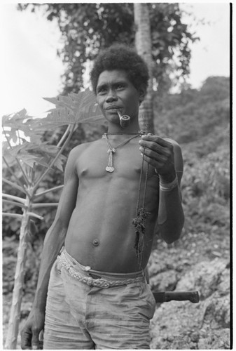 Laete'eboo the priest, holding object that is probably matala ancestral relic he is going to use in the ritual