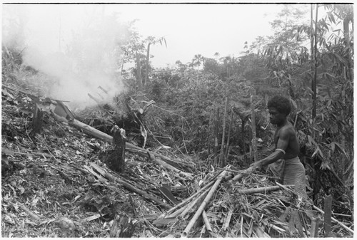 Man and woman burning off a garden