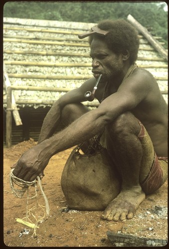 Portrait of man holding shell money