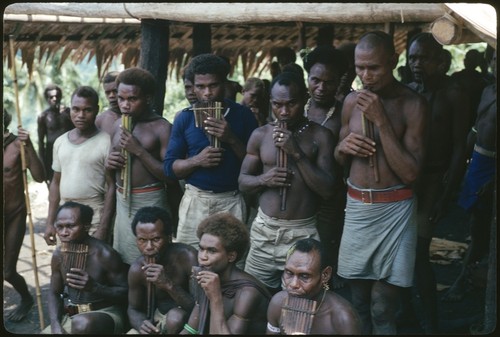 Men posing with panpipes