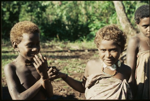 Young boy and girl with necklace of girimalaile clamshell pendants