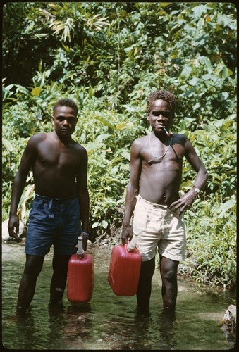 Boys carrying water for Keesing