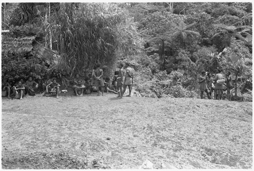 People waiting around in a clearing