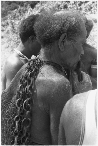 Alefo playing panpipes with wa'ifirua bag