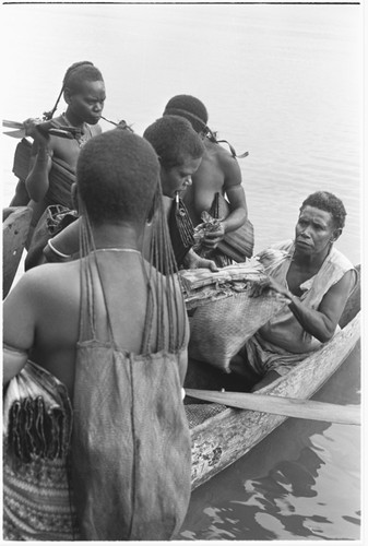 Trading with saltwater (coastal) women in the canoes