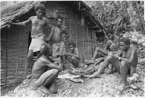 Eating ritual pork in front of men's house