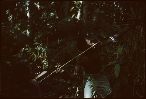 Folofo'u demonstrates spear throwing while Ri'aboo watches