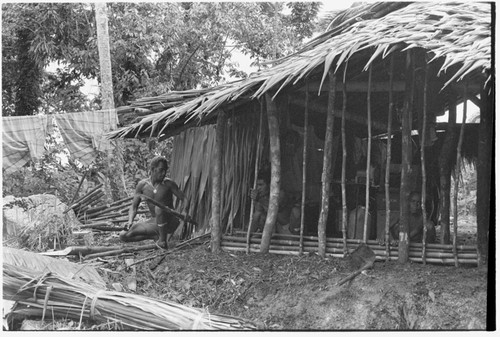 Ubuni, left, and Sale 'Oirukua, right, work on new house, Kwailala'e