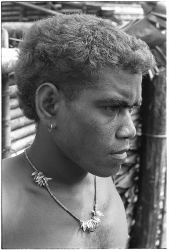 Portrait of boy with shell money and dolphin teeth necklace