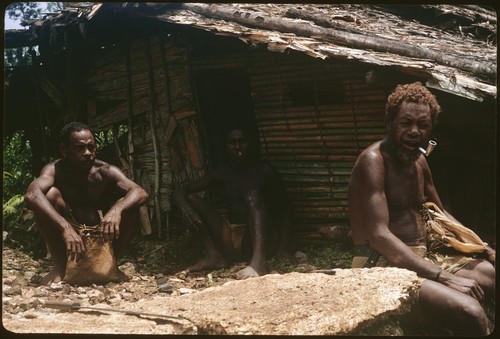 Men in front of house