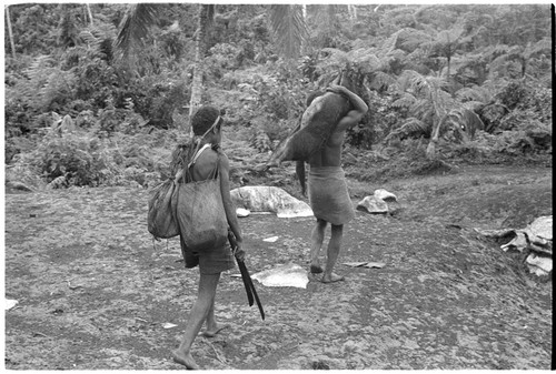 Young man carrying pig