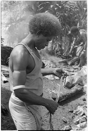 Portrait of man in t-shirt working with kofu shell money