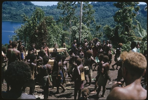 People carrying Keesing's stuff up from the coast