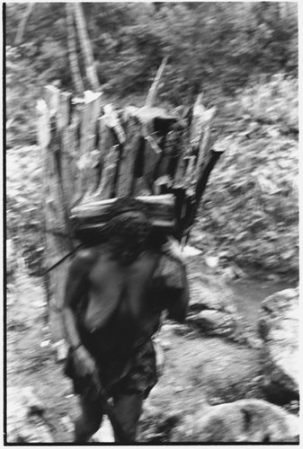 Woman with large load of wood