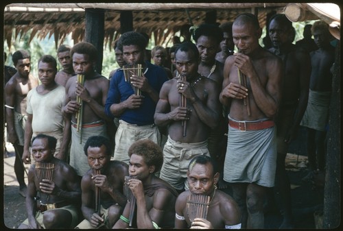 Men posing with panpipes