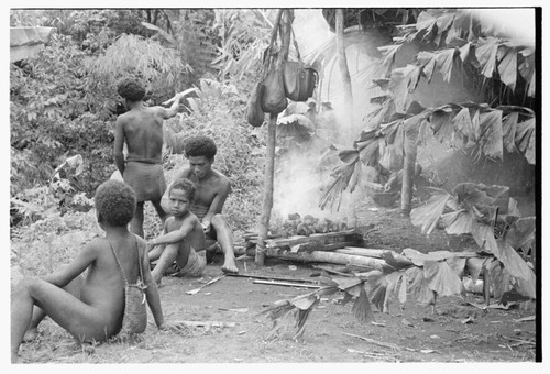 Men and boys standing outside the taualea, feasting shelter, after the ritual