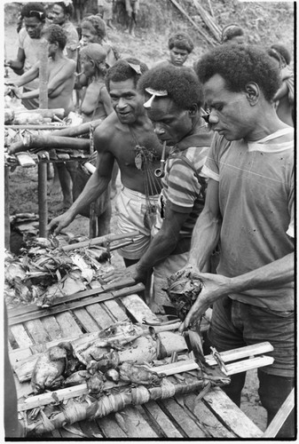 Men by platforms with food on them