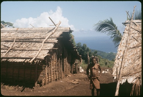 On the coastal rim, man in village