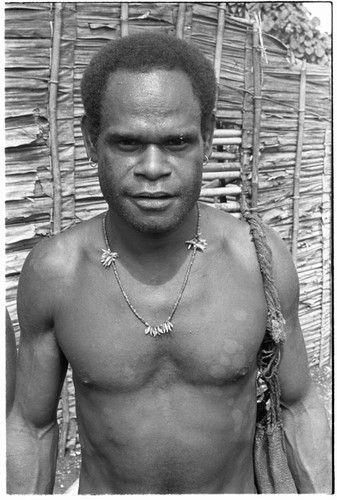 Young man with shell money and dolphin teeth necklace