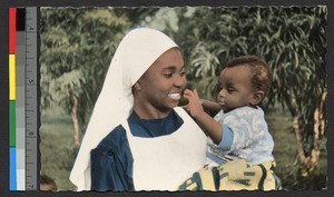 Woman holding child outdoors, Senegal, ca.1920-1940