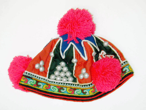 Child's hat with red pompoms
