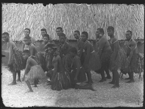 Men and boys posing near building