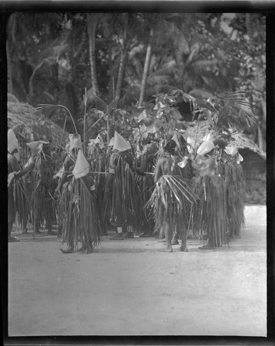 Group of people in ritual activity, wearing special attire