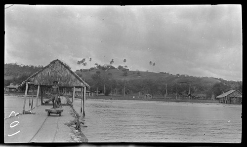 Man pushing cart on tracks at wharf at Lorengau, Manus