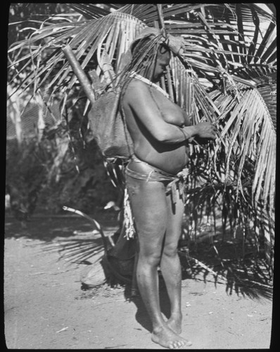 Woman carrying string bag on her head