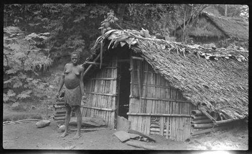 Woman in front of dwelling