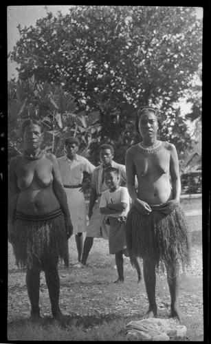 Women in grass skirts, and neckbands