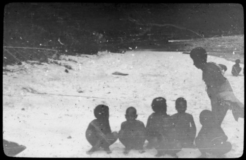 Man and children at the shore