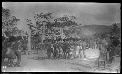 Motu men in circle, drumming and dancing near a dubu platform at Gaile, also spelled Gaire, a village in Central Province