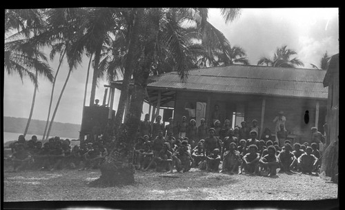 Hookworm lecture in front of a building