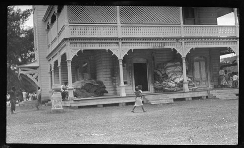 Verandah of royal palace, Tongatapu, with large piles of tapa and mats for ceremonial presentation