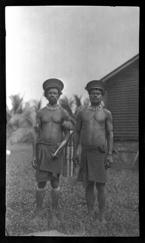 Two men in hats and neckalces