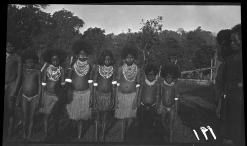 Children wearing layered necklaces