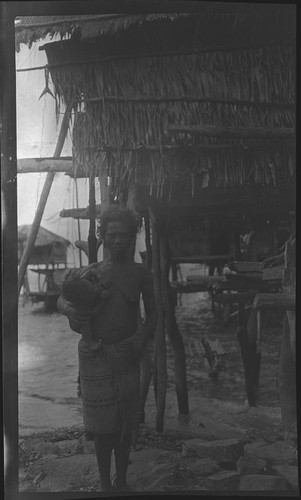 Woman and infant near house