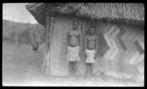 Two young women outside a house